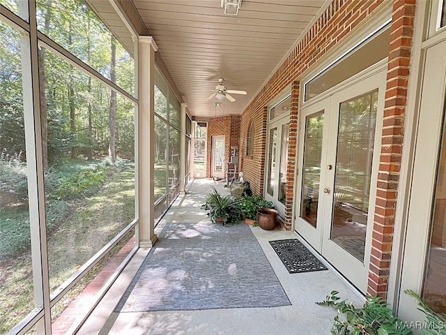 unfurnished sunroom with ceiling fan and french doors