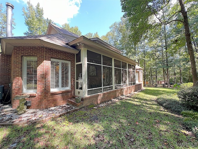 view of property exterior with a lawn and a sunroom