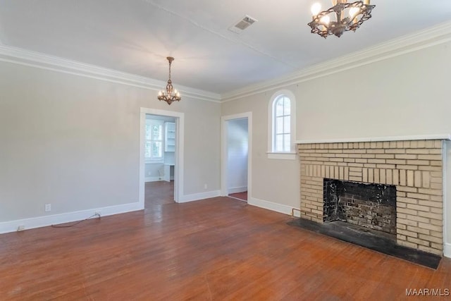 unfurnished living room featuring a fireplace, hardwood / wood-style floors, a chandelier, and ornamental molding