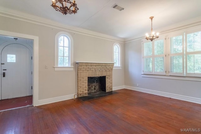 unfurnished living room with a notable chandelier, ornamental molding, and plenty of natural light