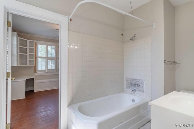 bathroom with shower / washtub combination, hardwood / wood-style floors, and vanity