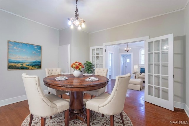 dining room featuring a notable chandelier, crown molding, and dark wood-type flooring