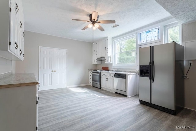 kitchen featuring white cabinets, ceiling fan, light hardwood / wood-style floors, and appliances with stainless steel finishes