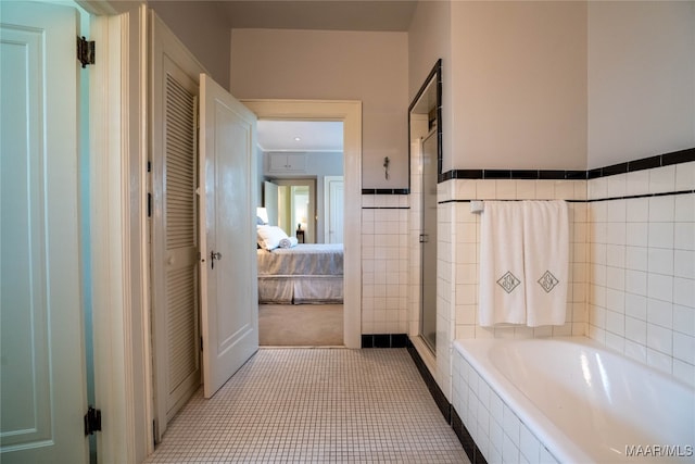 bathroom featuring shower with separate bathtub and tile patterned flooring