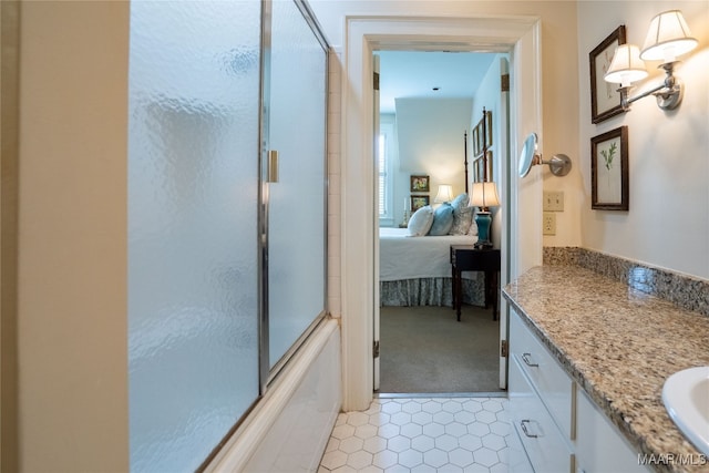 bathroom with shower / bath combination with glass door, vanity, and tile patterned floors