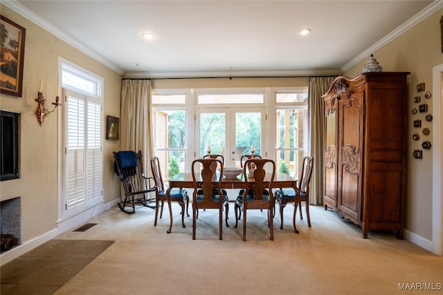 carpeted dining area featuring crown molding and french doors