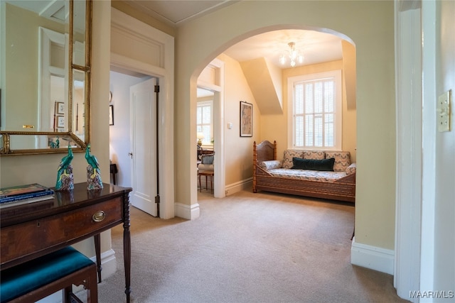 living area featuring an inviting chandelier and light colored carpet