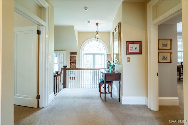 hallway with light colored carpet