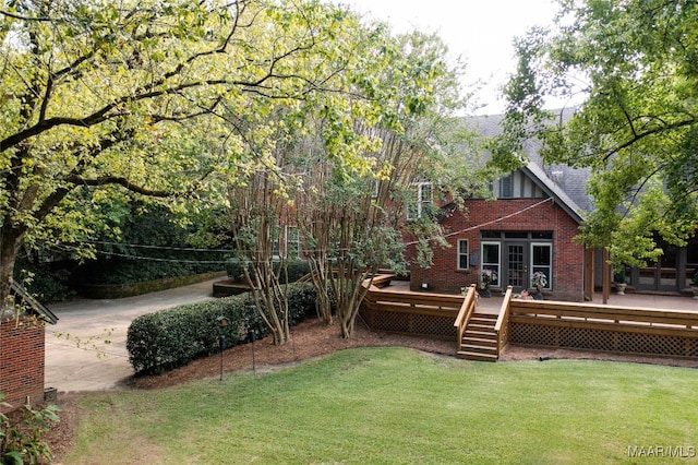 view of yard featuring a deck and french doors