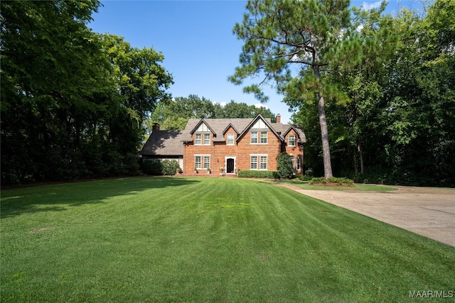 tudor-style house with a front lawn