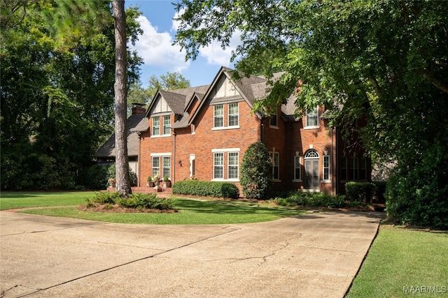 english style home with a front yard