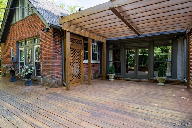 wooden deck featuring a pergola and french doors