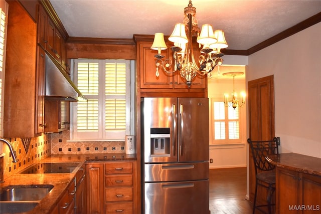 kitchen featuring pendant lighting, tasteful backsplash, a notable chandelier, dark hardwood / wood-style flooring, and stainless steel fridge