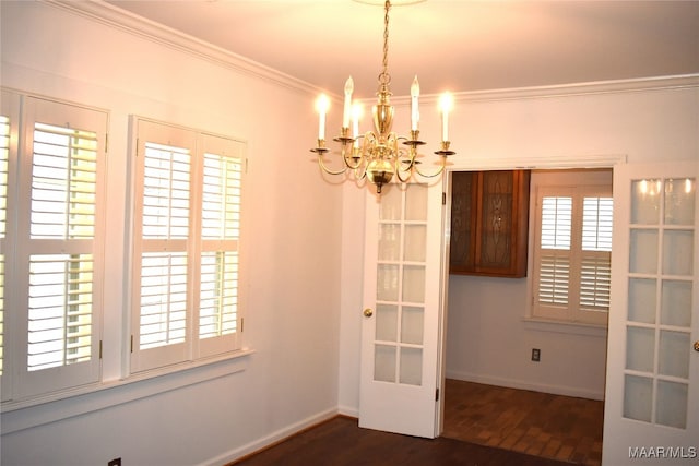 unfurnished dining area featuring a chandelier, dark hardwood / wood-style floors, and crown molding