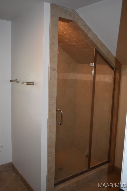 bathroom featuring tile patterned flooring and a shower with door