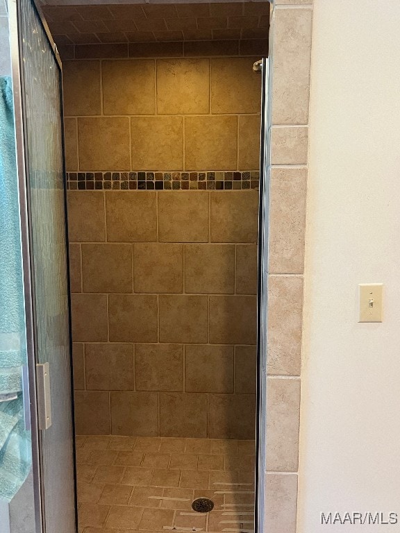 bathroom with a shower with door