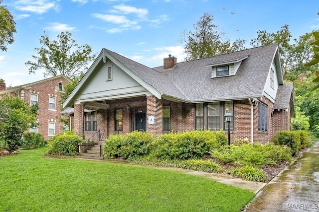 view of front of home featuring a front yard and a porch