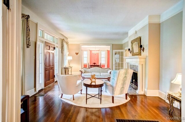 living room featuring hardwood / wood-style floors and crown molding