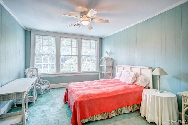 carpeted bedroom featuring crown molding and ceiling fan