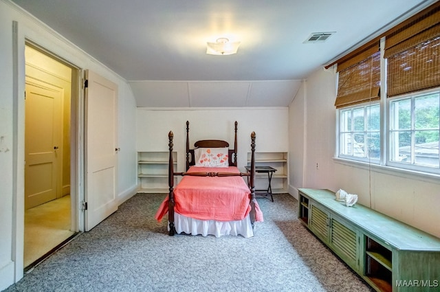 carpeted bedroom with vaulted ceiling