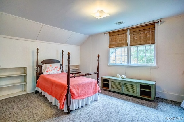 carpeted bedroom with lofted ceiling