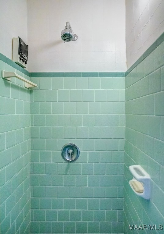 bathroom with a tile shower