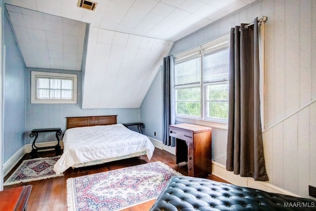 bedroom with vaulted ceiling and dark hardwood / wood-style floors