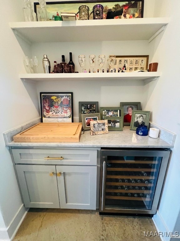 bar featuring gray cabinetry and beverage cooler