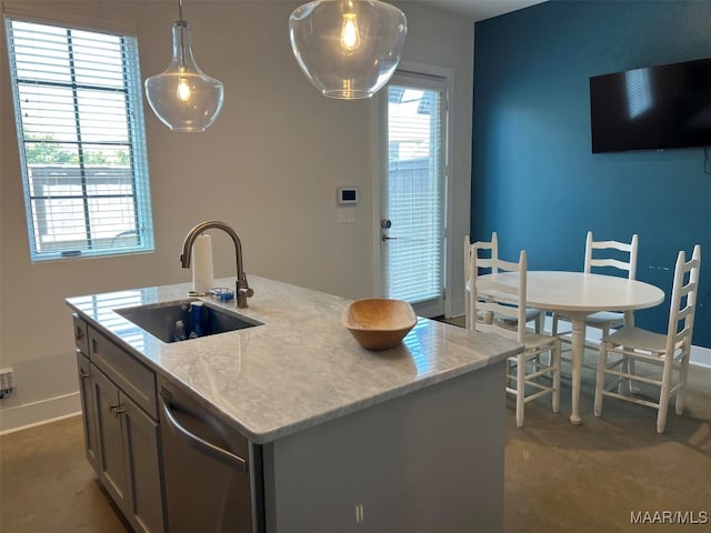 kitchen with pendant lighting, sink, a center island with sink, light stone countertops, and stainless steel dishwasher