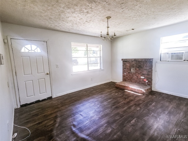 entryway with a healthy amount of sunlight, dark wood-type flooring, a chandelier, and cooling unit