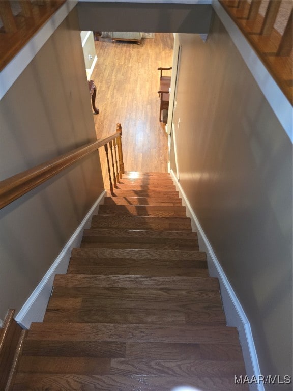 stairway featuring hardwood / wood-style floors