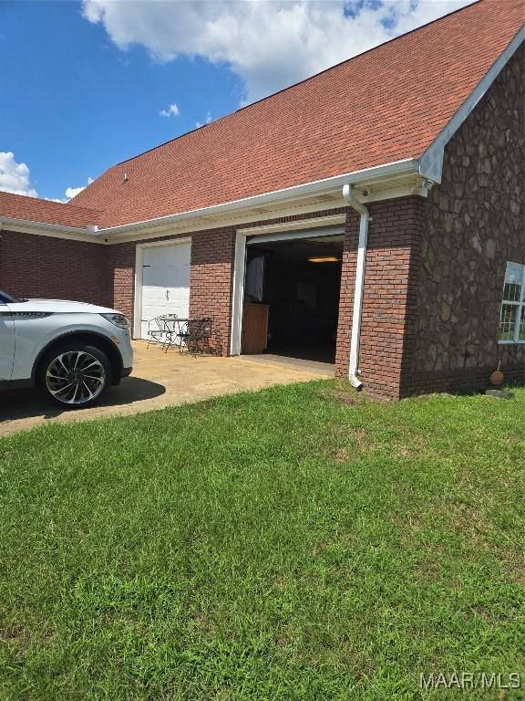 view of property exterior featuring a yard and a garage