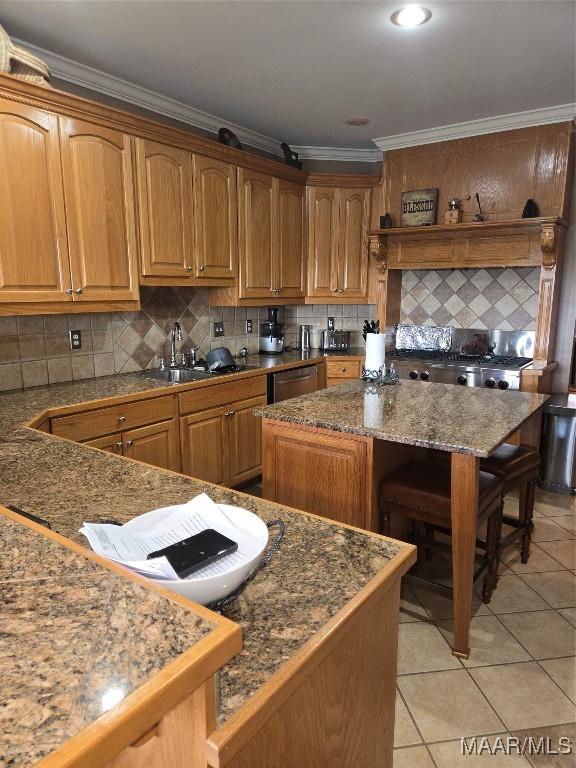 kitchen with light tile patterned floors, sink, ornamental molding, a center island, and decorative backsplash