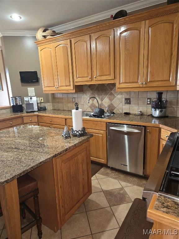 kitchen featuring light tile patterned floors, ornamental molding, stainless steel dishwasher, dark stone countertops, and decorative backsplash