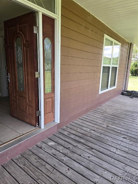 view of exterior entry with a porch