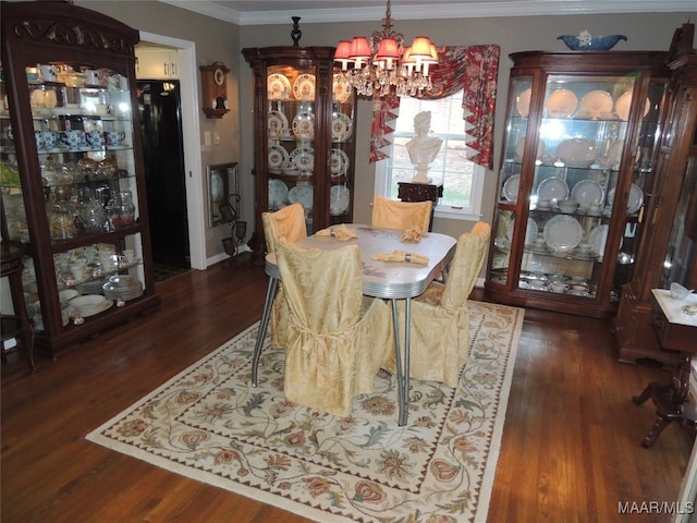 dining area with an inviting chandelier, ornamental molding, and dark wood-type flooring