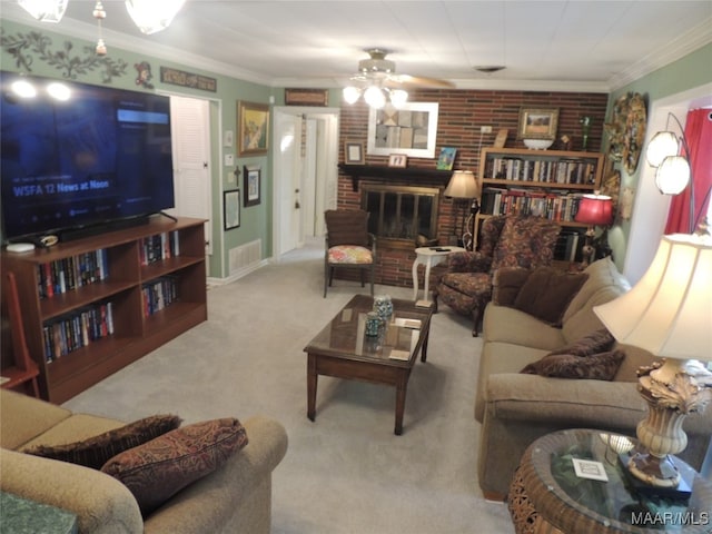 carpeted living room featuring crown molding, ceiling fan, and a brick fireplace