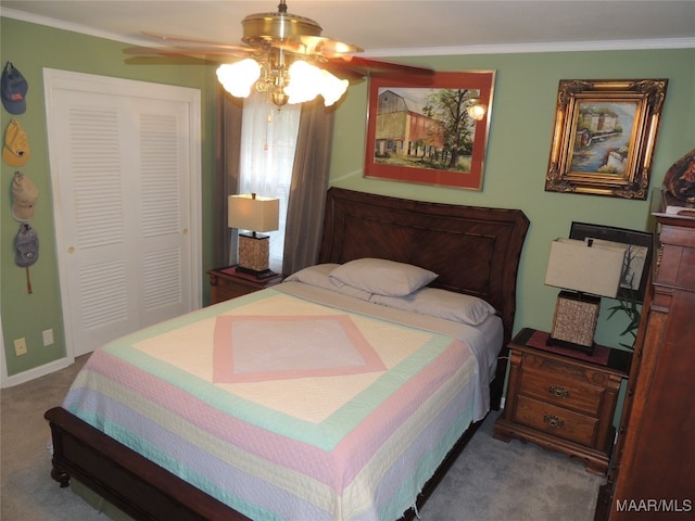 carpeted bedroom with a closet, ceiling fan, and crown molding