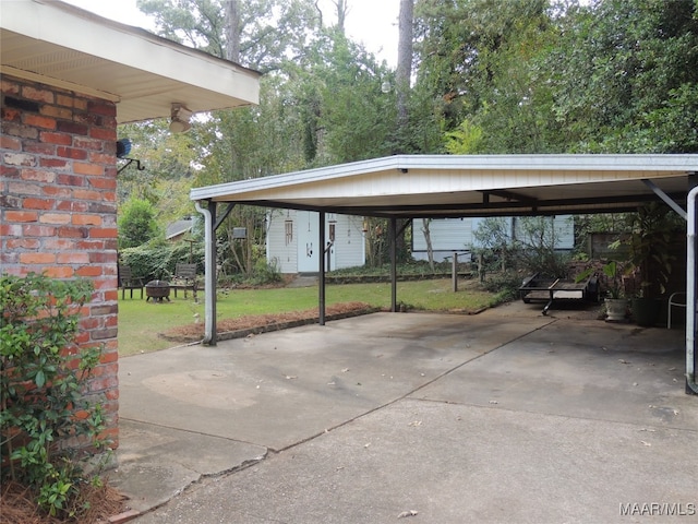 view of parking with a yard and a carport