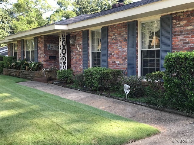 ranch-style home featuring a porch and a front lawn