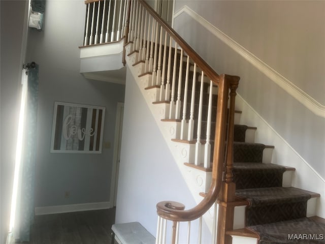 stairway with hardwood / wood-style floors