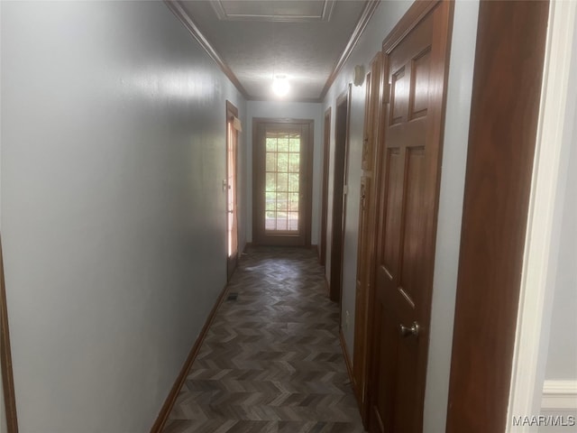 corridor featuring crown molding, dark parquet floors, and a textured ceiling