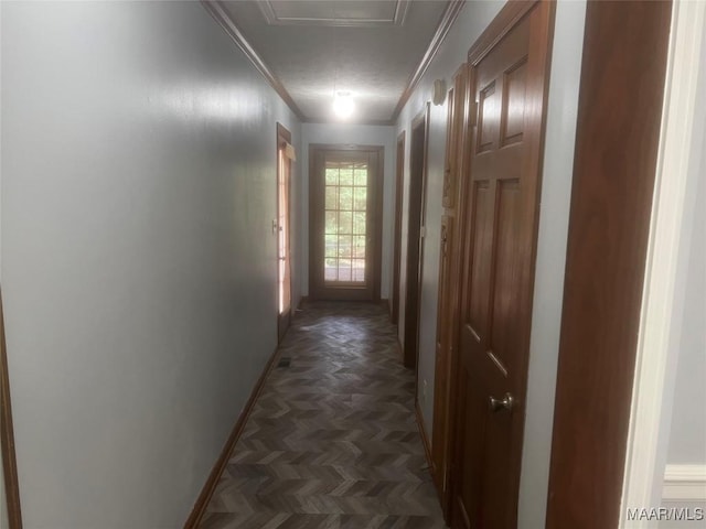 corridor featuring baseboards and ornamental molding