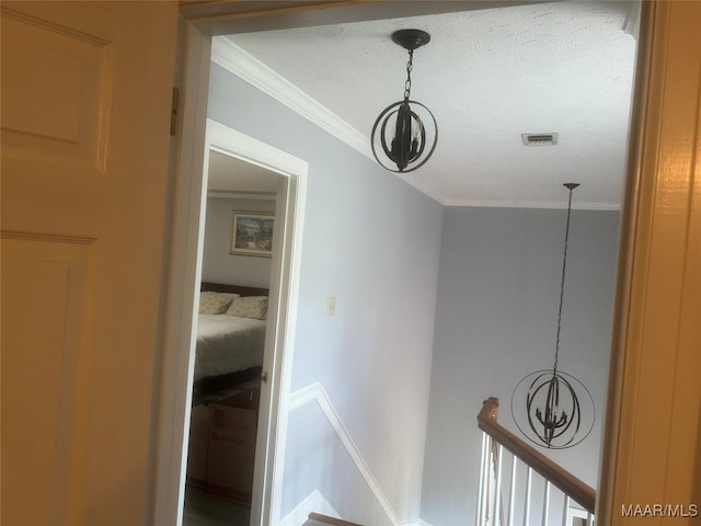 room details featuring ornamental molding and a textured ceiling