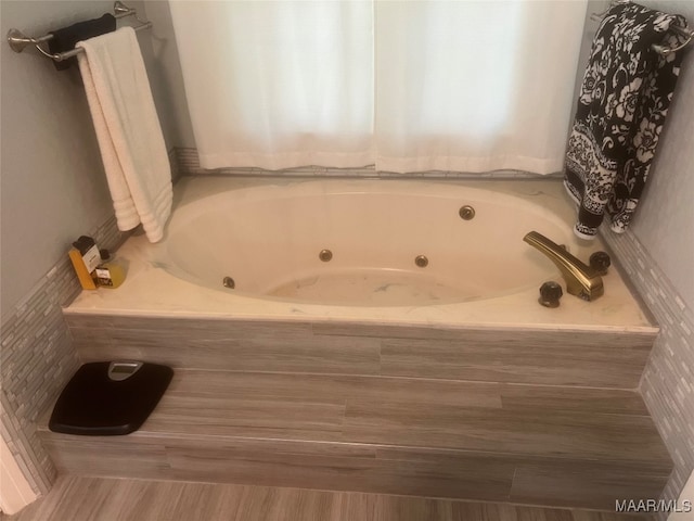 bathroom with tiled bath