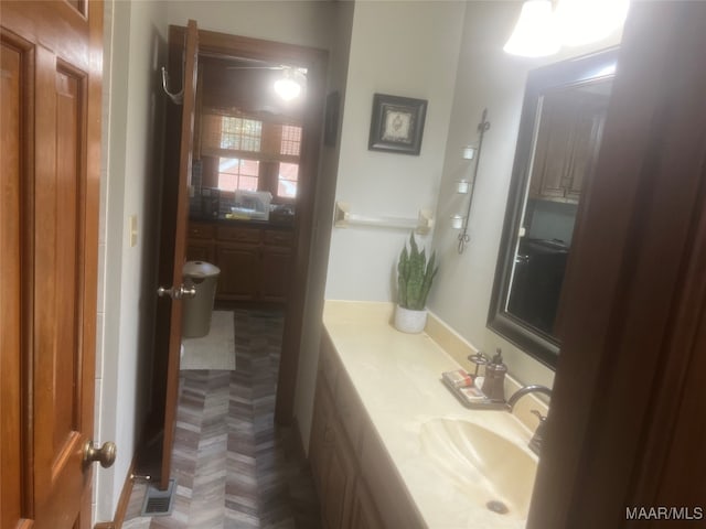 bathroom with vanity and parquet floors