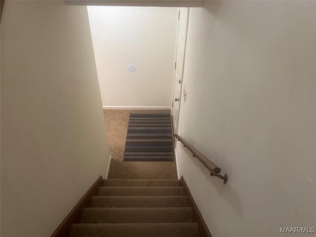 staircase with carpet floors and baseboards