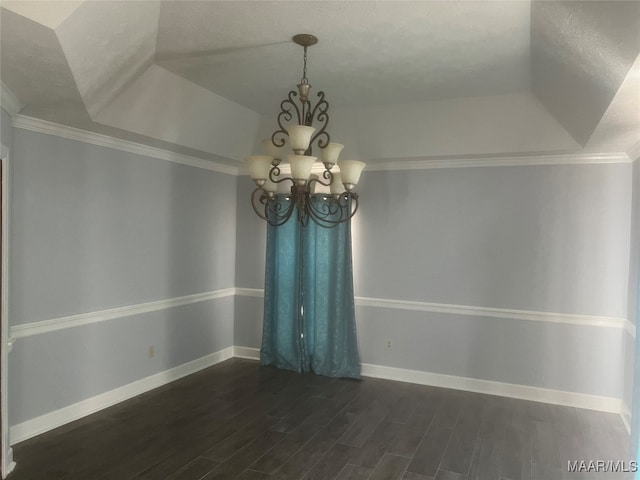 unfurnished room with dark wood-type flooring, crown molding, a notable chandelier, and a tray ceiling