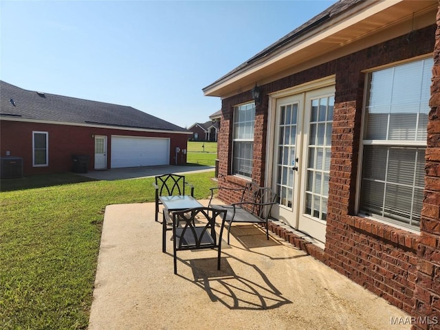 view of patio featuring cooling unit and a garage