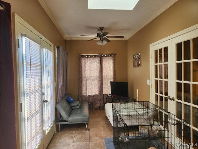 living area featuring french doors, ceiling fan, ornamental molding, and light tile patterned flooring